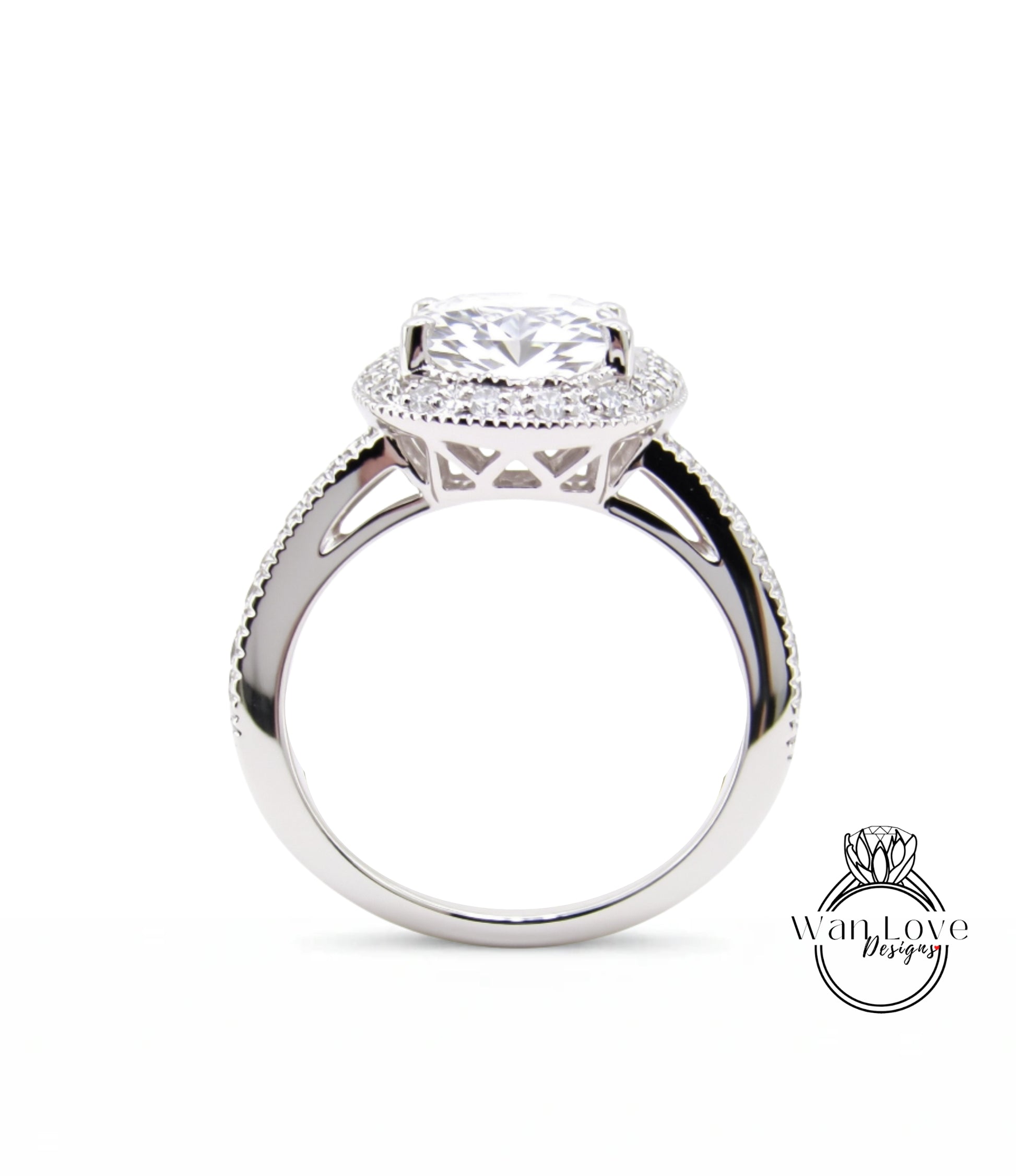 A close-up view of a silver engagement ring with a large central diamond surrounded by smaller diamonds, set in a halo of smaller diamonds.