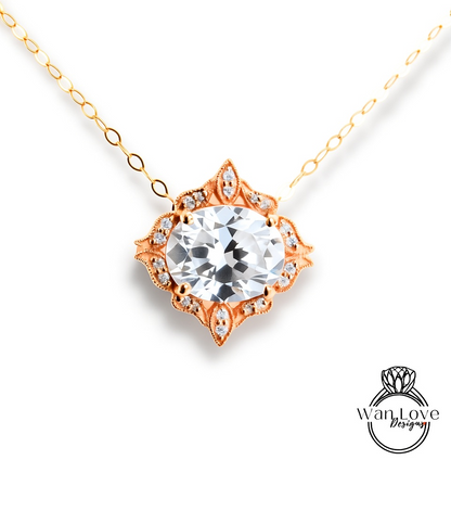 A necklace with a large, clear gemstone at the center, surrounded by an ornate, floral-designed metal frame.