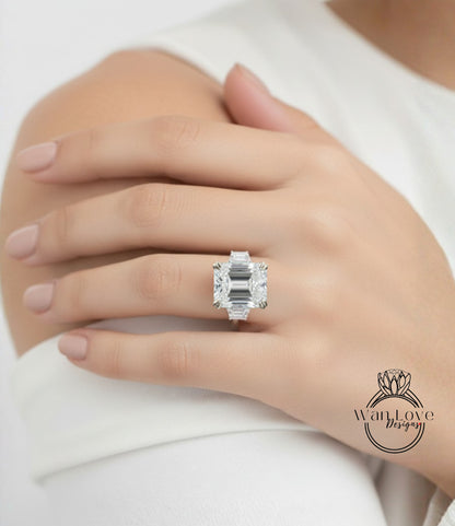 A close-up of a person's hand wearing a large, sparkling diamond ring.