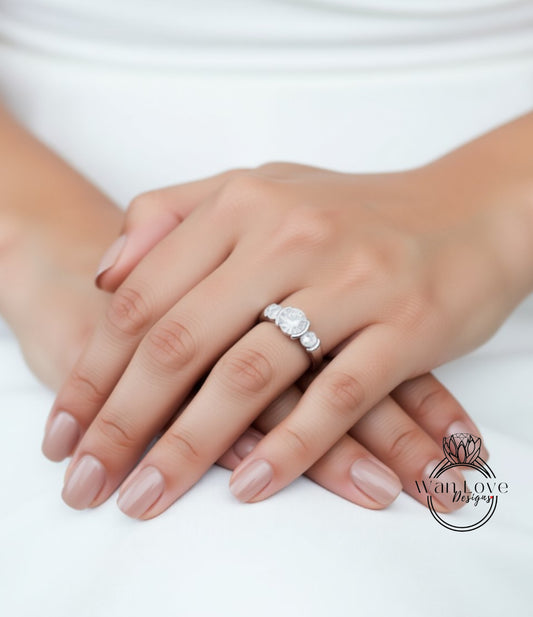 A close-up image of a person's hands wearing a diamond engagement ring.