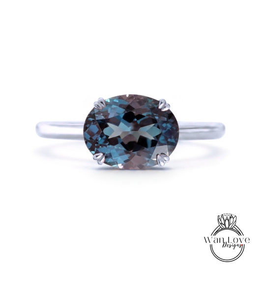 A silver ring with a large, round blue gemstone set in the center.