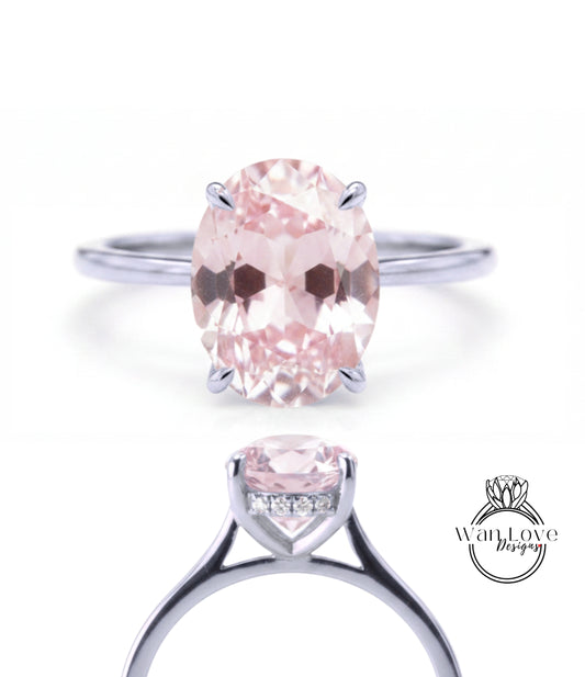 A close-up view of a silver ring with a large oval-shaped pink gemstone, showcasing the intricate design and craftsmanship of the piece.
