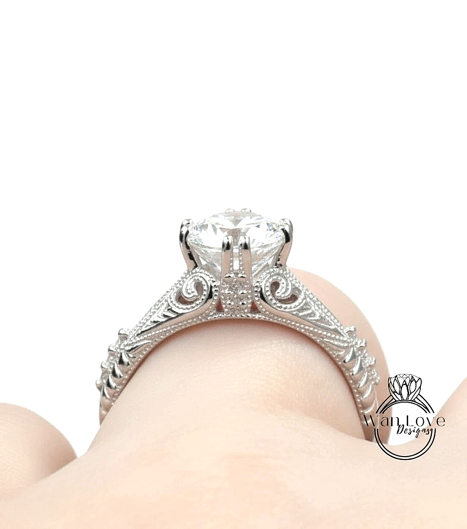 A close-up view of a diamond engagement ring on a person's finger.