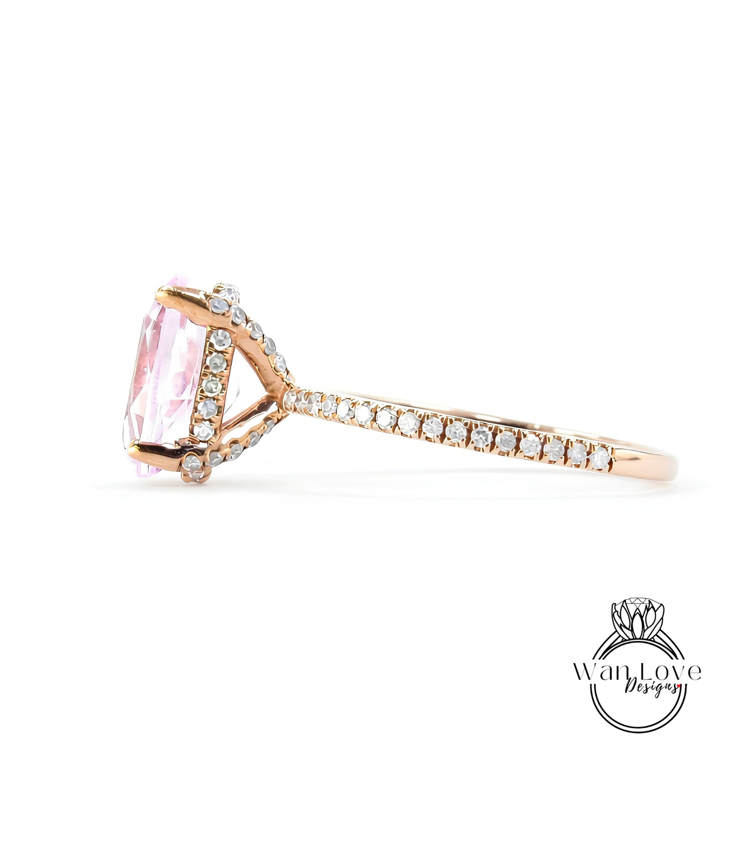A close-up view of a gold ring with a large pink gemstone, possibly a diamond, set in the center.