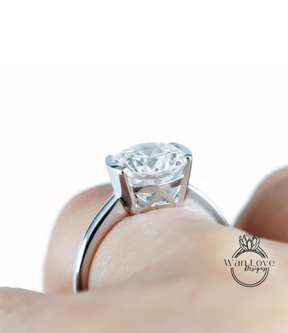 A close-up of a person's hand wearing a large, diamond-encrusted ring.