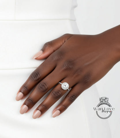 A close-up of a hand wearing a diamond engagement ring.