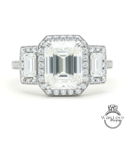 A close-up of a diamond engagement ring with a large central diamond surrounded by smaller diamonds on either side.