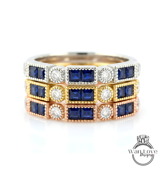 A ring with three concentric bands, each adorned with a blue gemstone and a diamond. The gemstones are arranged in a repeating pattern, creating a visually appealing design.
