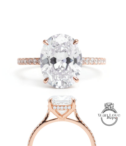 a large oval-shaped diamond engagement ring with a rose gold band and a halo of smaller diamonds around the center stone.
