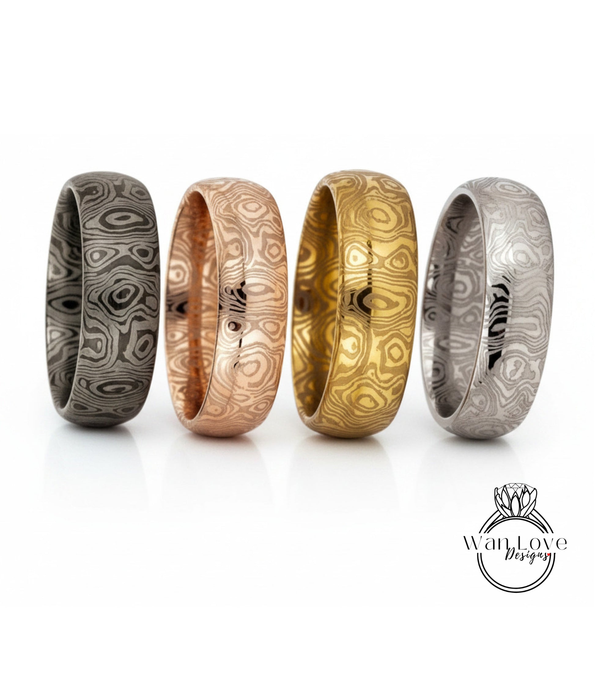 four unique rings with different designs and colors, arranged in a row.