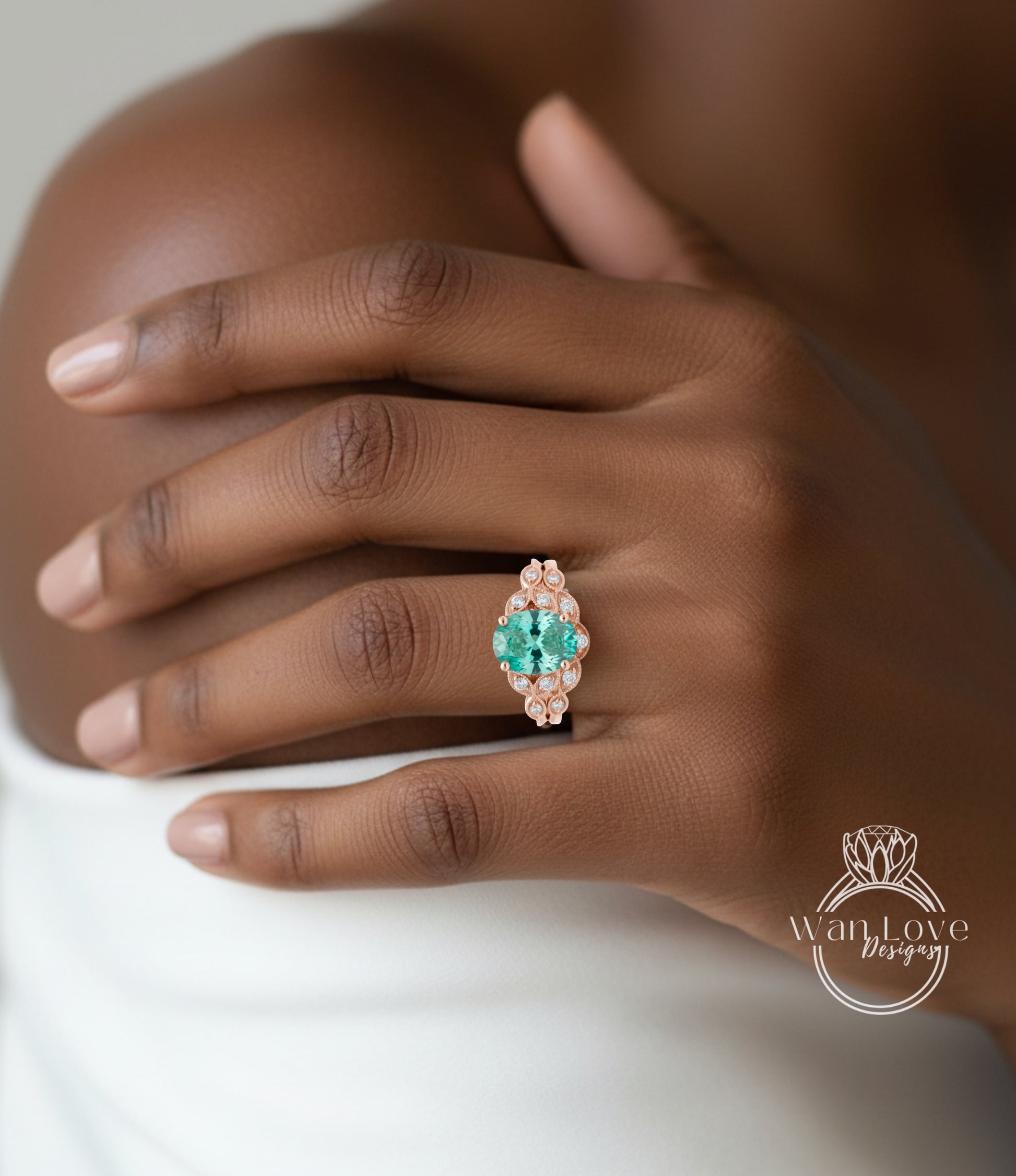 A close-up of a hand wearing a ring with a large, colorful gemstone set in a decorative piece of jewelry.