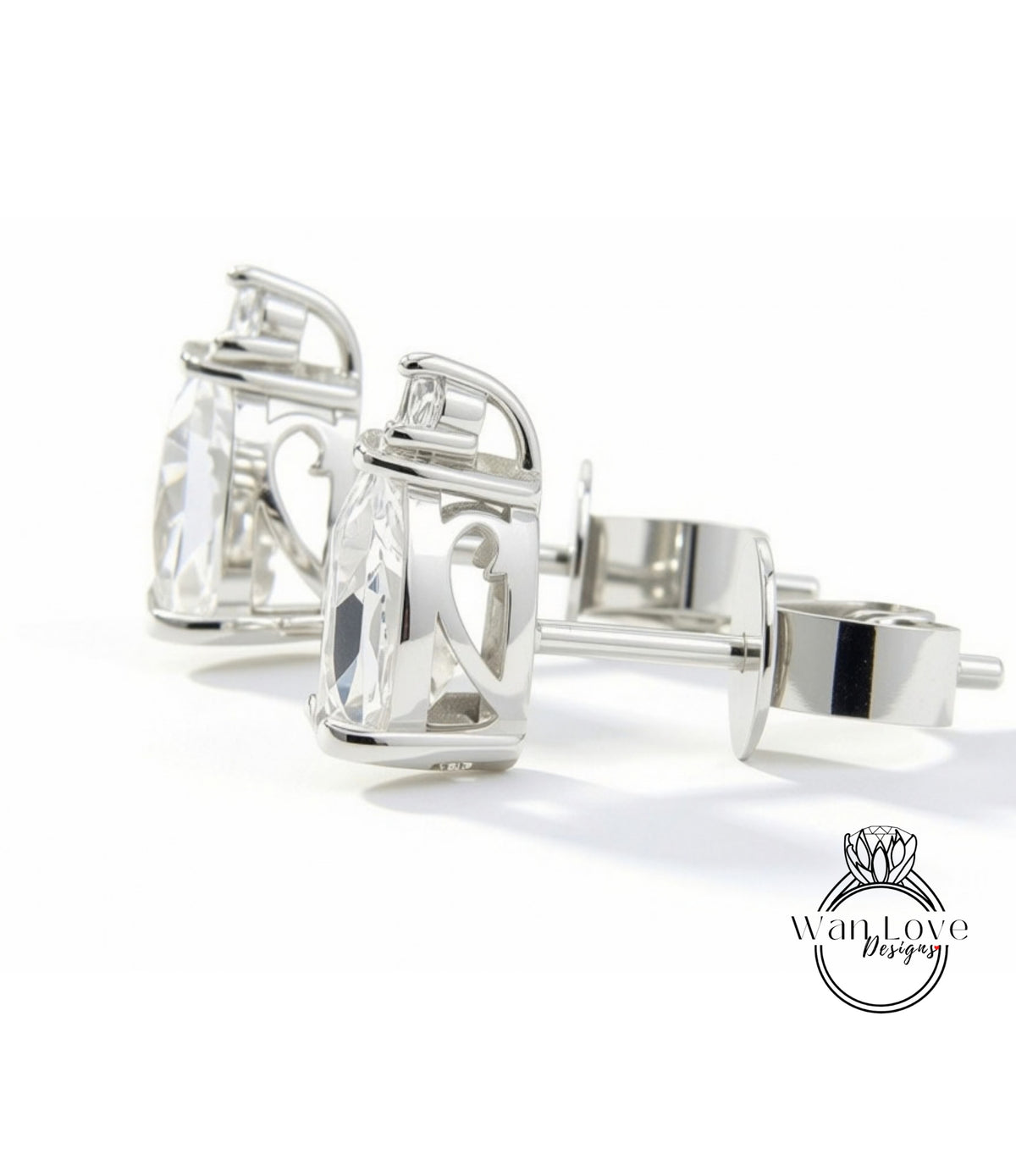 A pair of elegant silver earrings with clear gemstones, displayed on a white background.