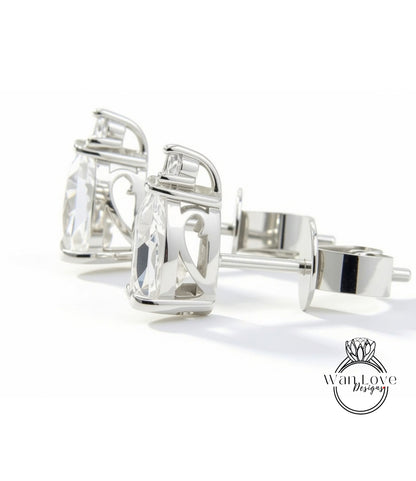 A pair of elegant silver earrings with clear gemstones, displayed on a white background.