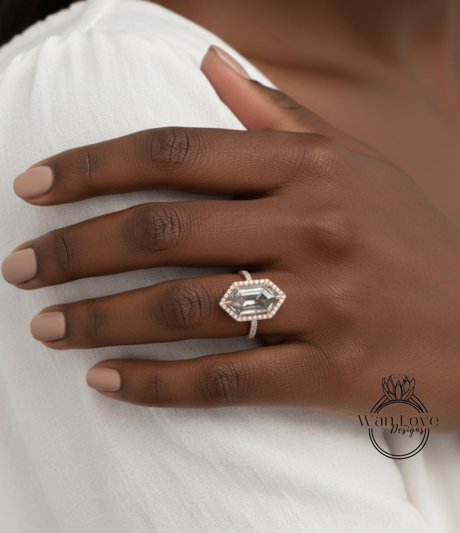 A close-up of a hand wearing a large, ornate ring with a large gemstone.