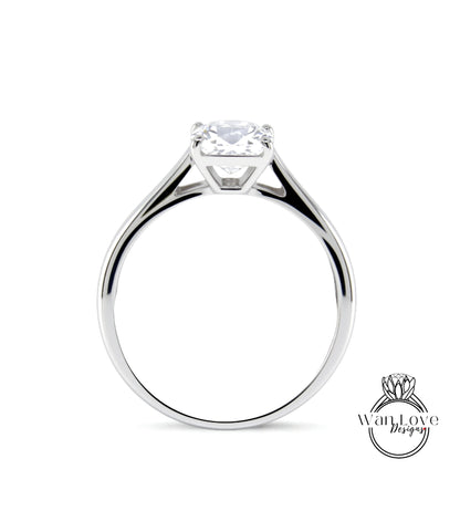 A silver engagement ring with a large diamond set in the center.