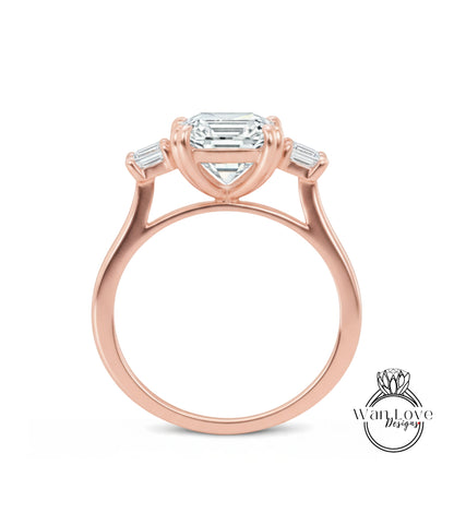 A rose gold engagement ring with a large central diamond and three smaller diamonds on either side.
