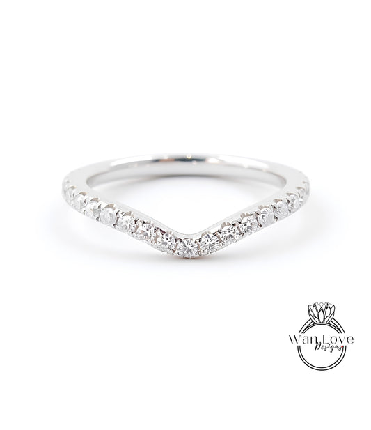 A silver ring with a v-shaped band and small diamonds set in it.