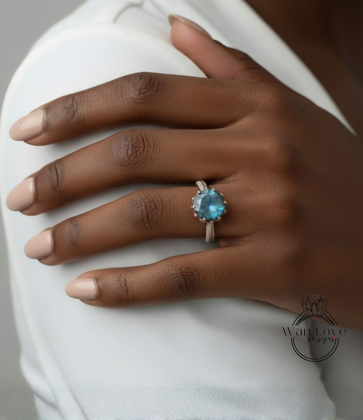 A close-up of a person's hand wearing a ring with a blue gemstone.
