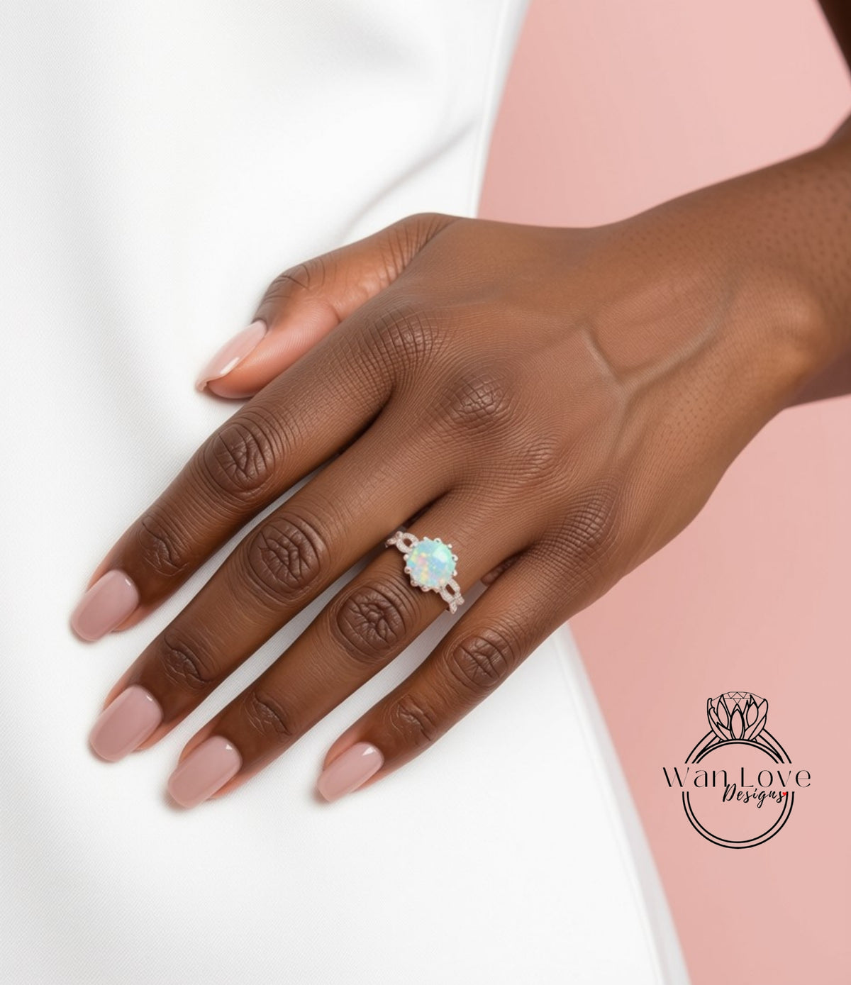 A close-up of a hand wearing a ring with a large, colorful gemstone.