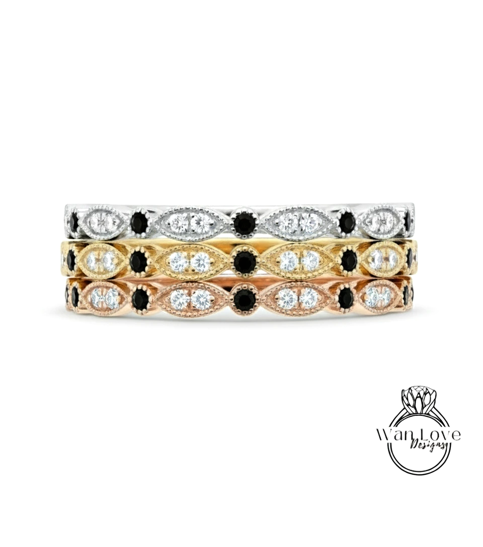 A stack of three rings with diamonds and pearls.