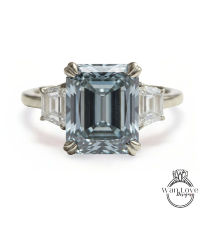 A large, blue diamond engagement ring with three smaller diamonds on either side.