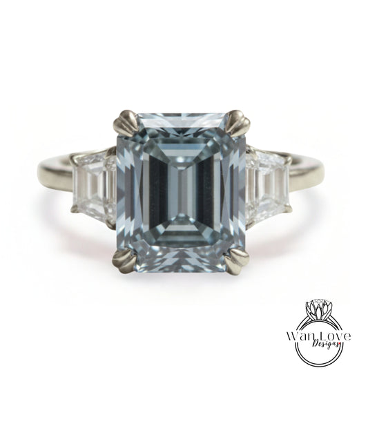 A large, blue diamond engagement ring with three smaller diamonds on either side.