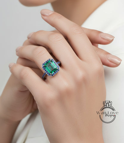 A close-up of a person's hand wearing a large, ornate ring with a large, green gemstone.