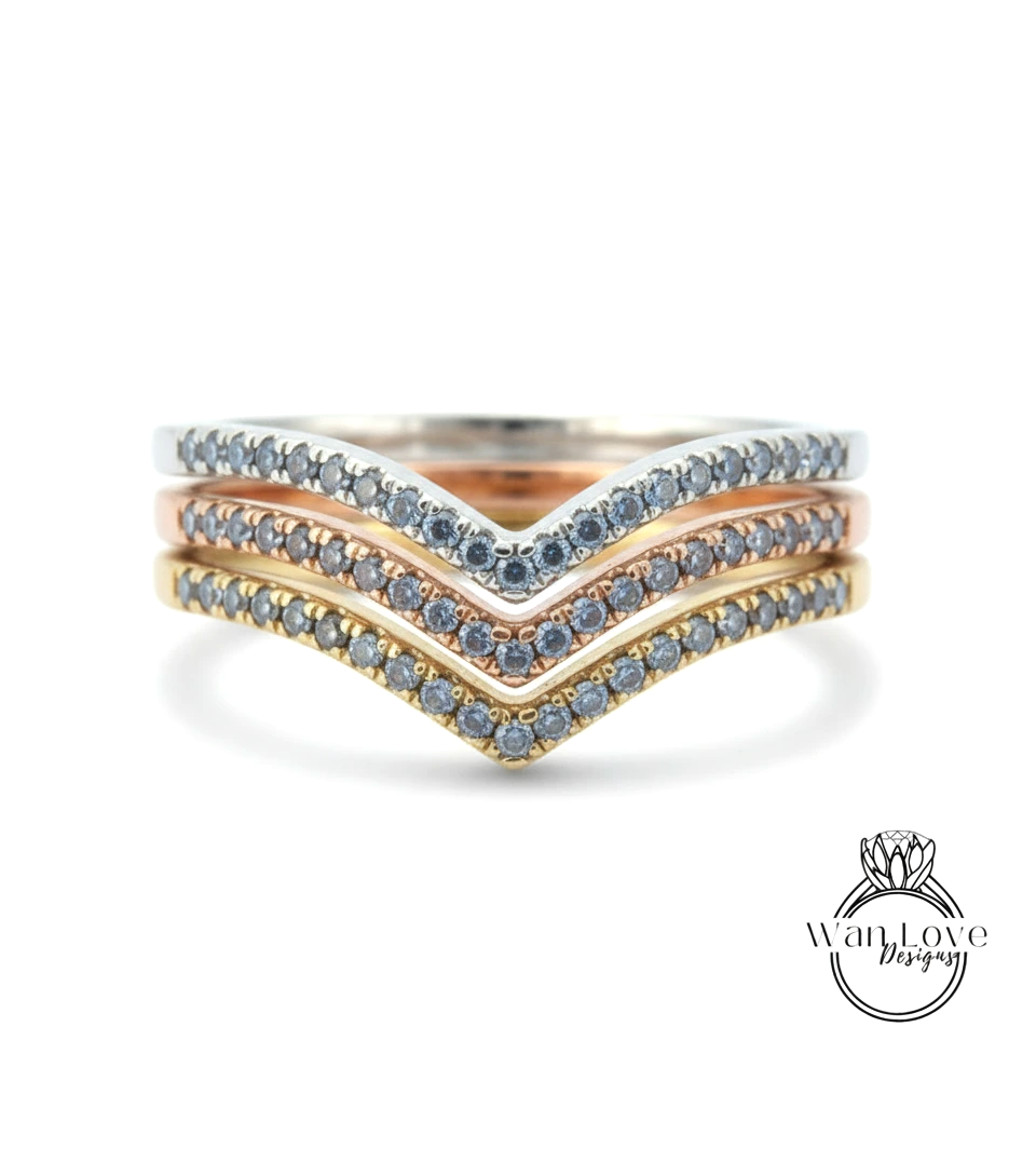 A ring with three layers of rings, each with a diamond set in a different color.