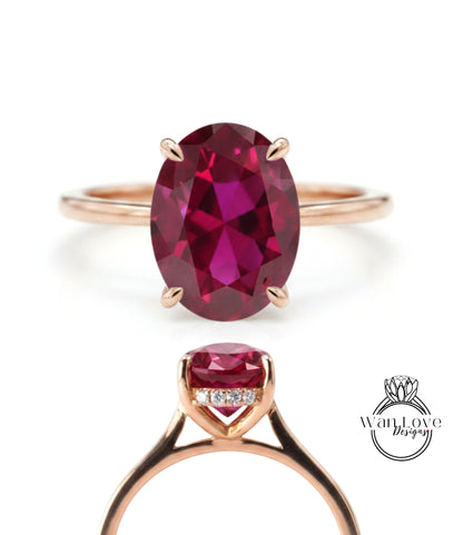 a gold ring with a large oval-shaped gemstone, which appears to be a deep red gemstone.