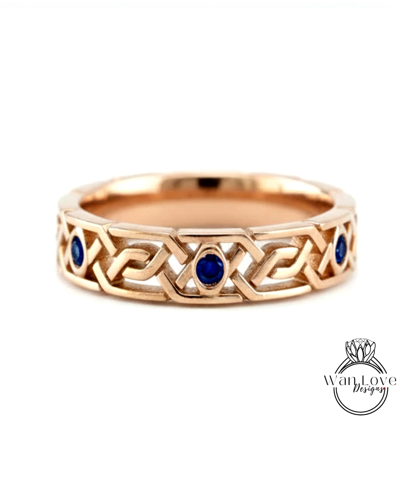 A gold ring with a Celtic knot design and blue gemstones.