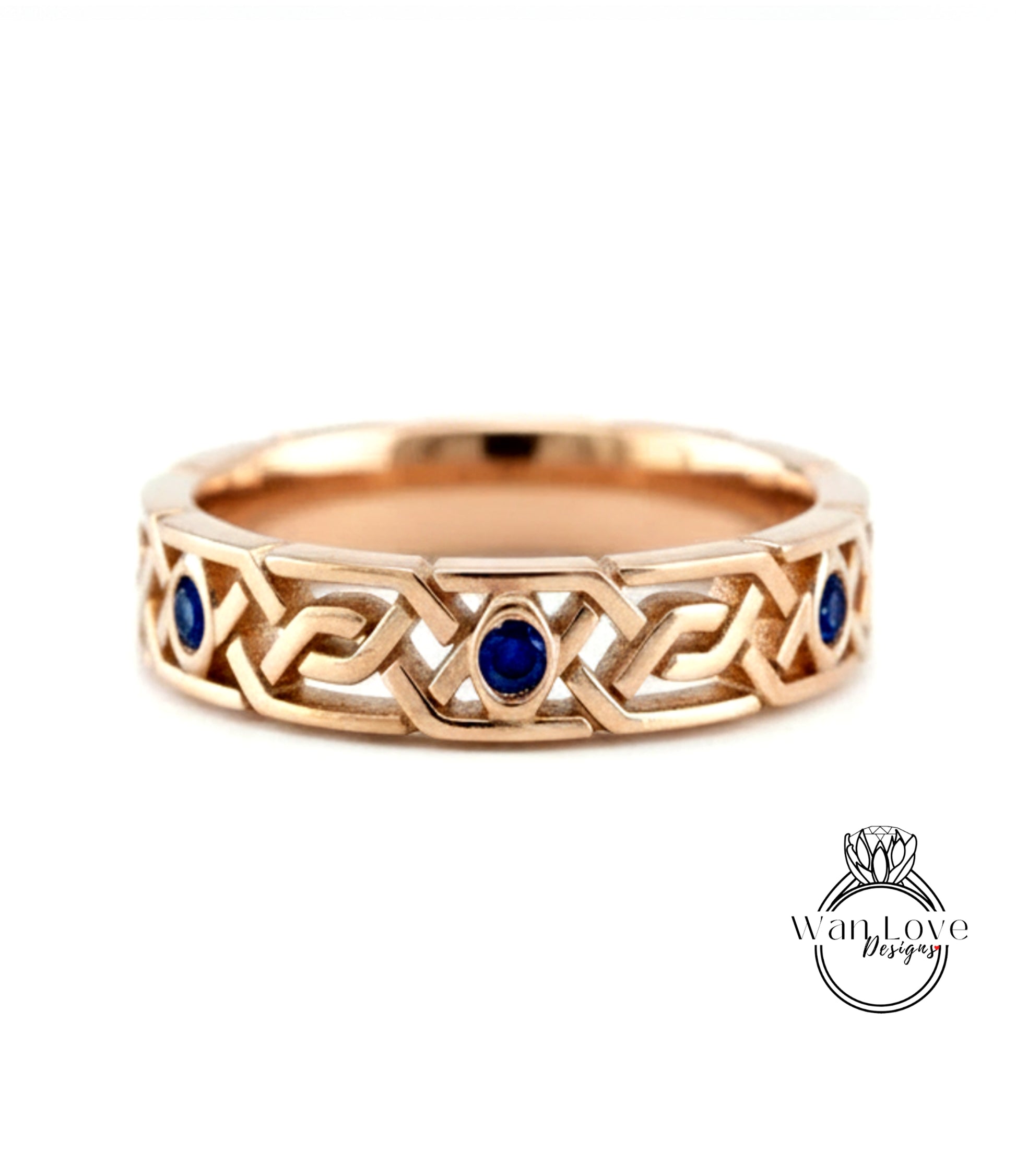 A gold ring with a Celtic knot design and blue gemstones.