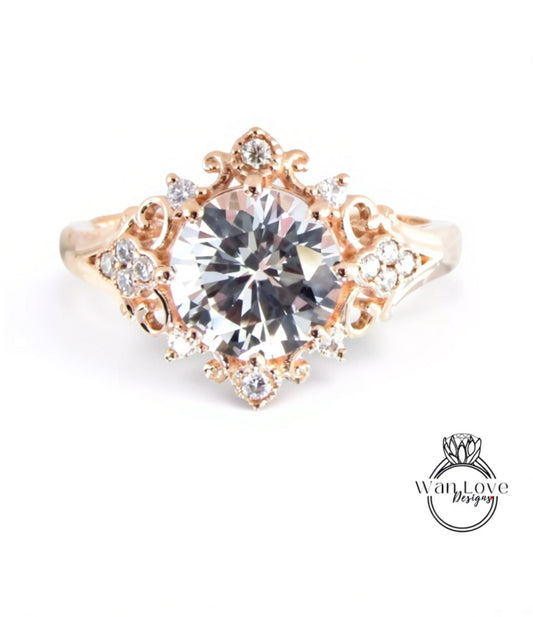 A gold ring with a large, clear gemstone at the center, surrounded by smaller diamonds and intricate designs.