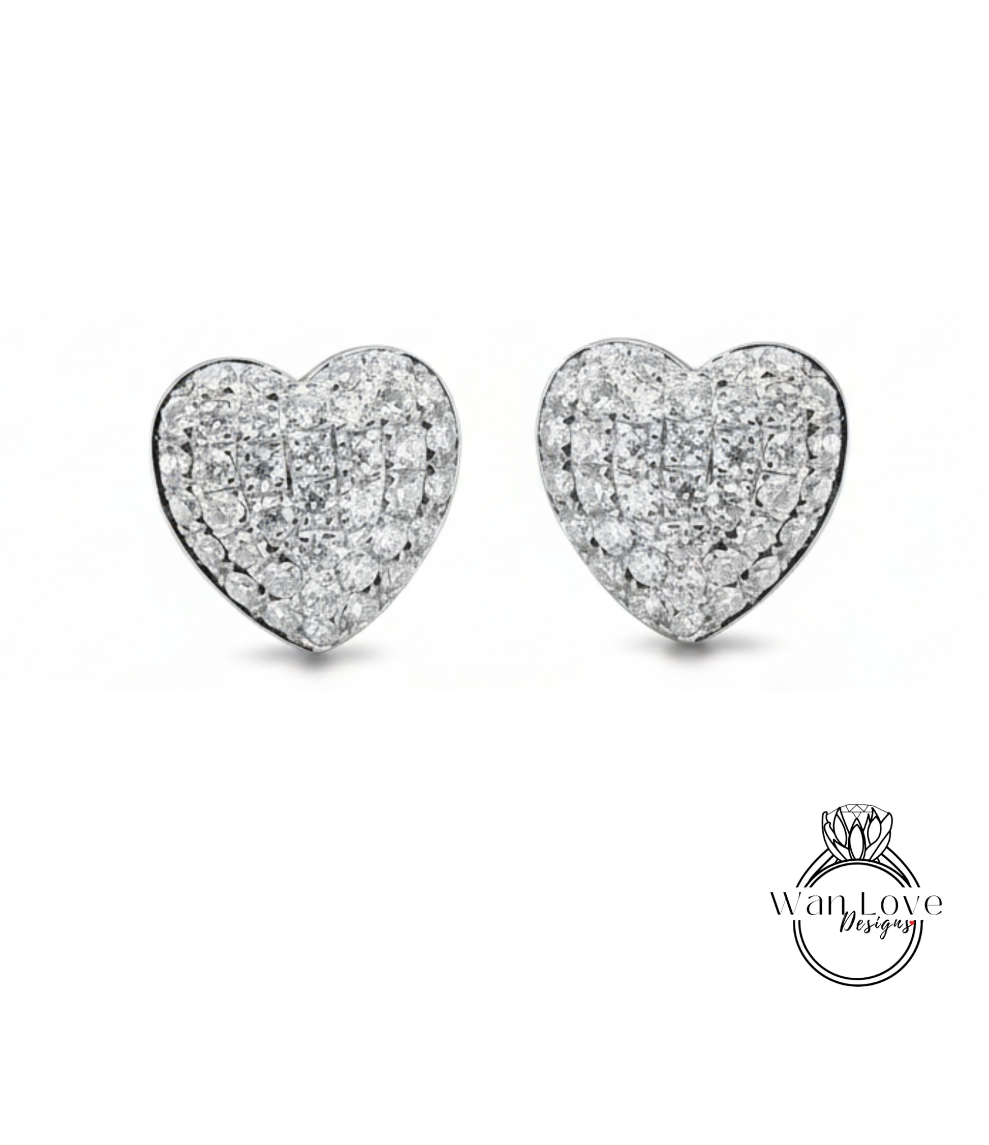 A pair of elegant diamond-encrusted heart-shaped earrings against a white background.
