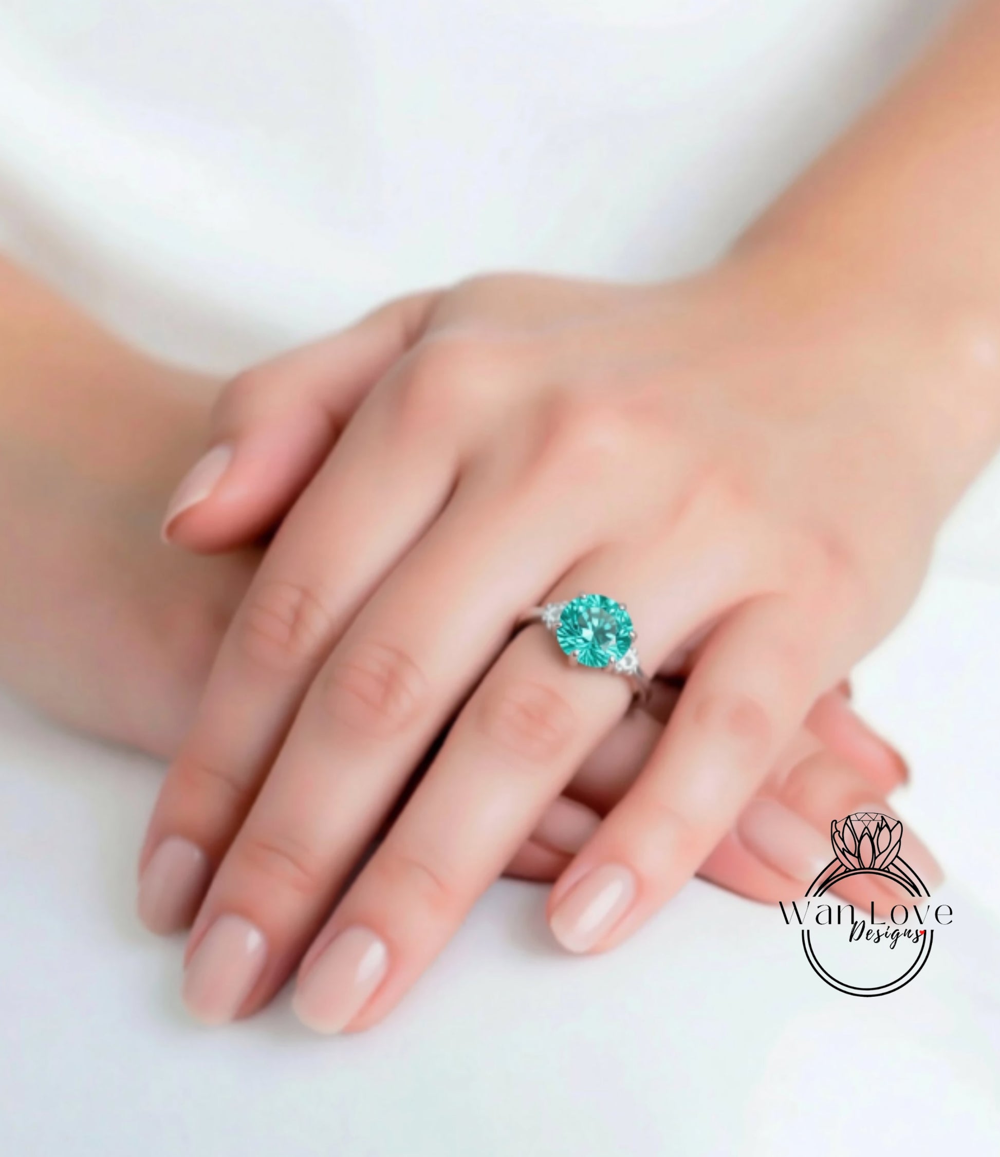A close-up of a person's hand wearing a ring with a large, turquoise gemstone.