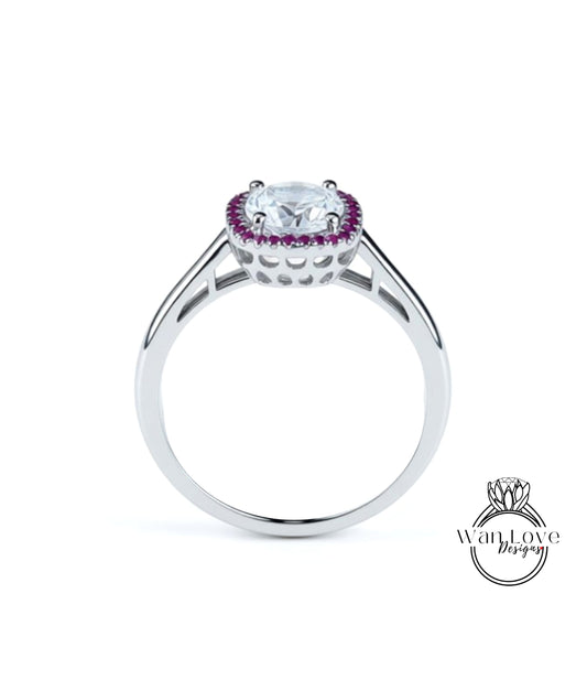 A silver ring with a large central gemstone surrounded by smaller purple stones.