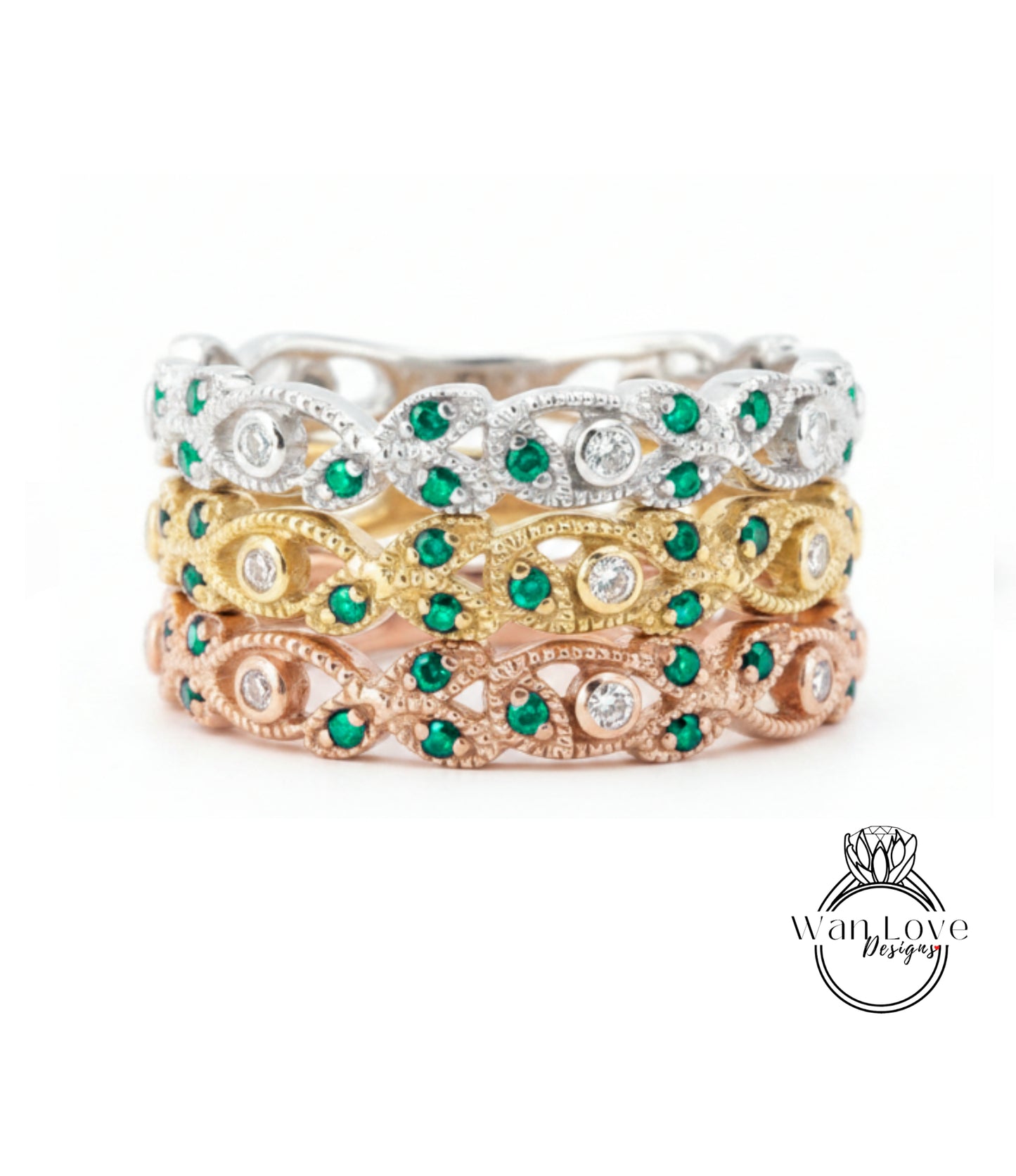 A stack of three rings with green gemstones and diamonds set in various colored metals, including silver, gold, and rose gold.