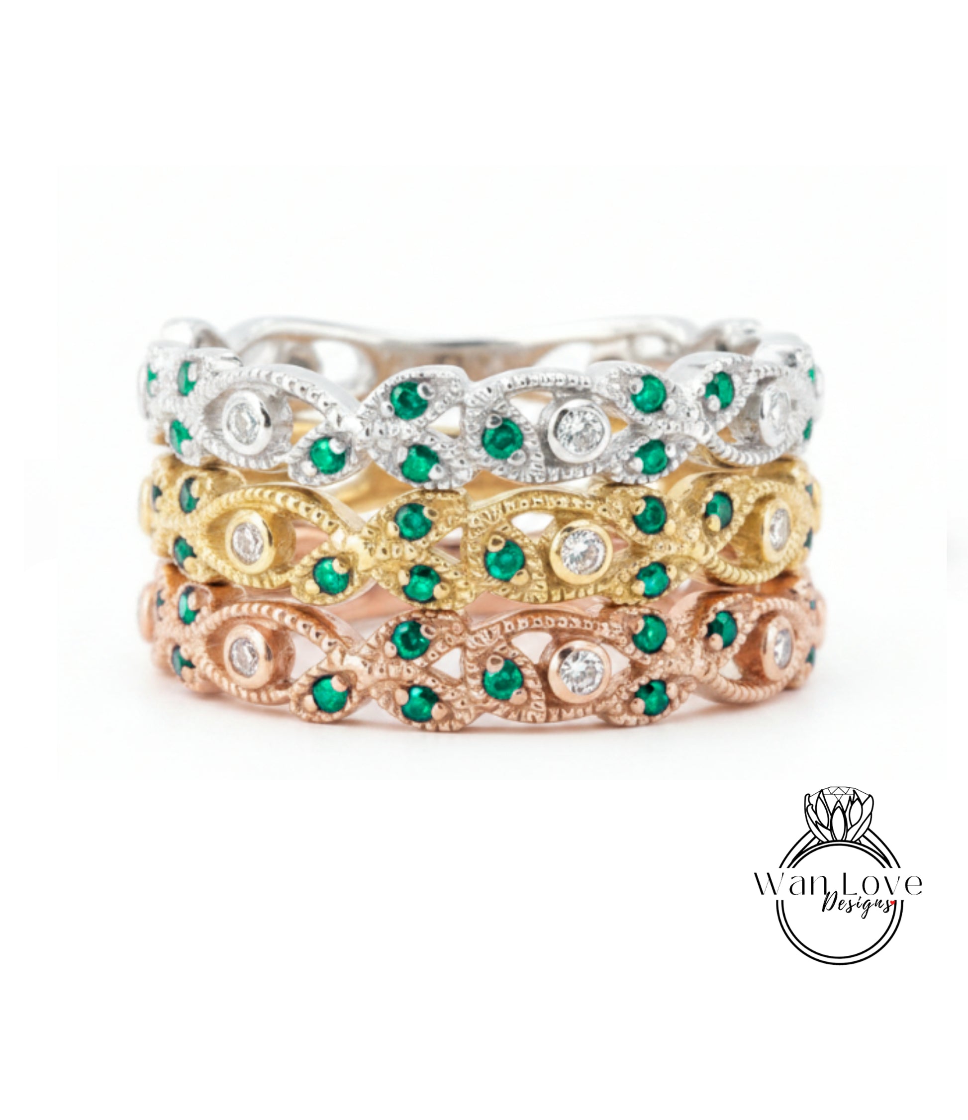 A stack of three rings with green gemstones and diamonds set in various colored metals, including silver, gold, and rose gold.