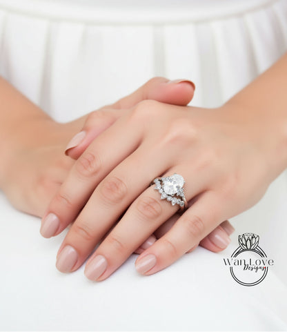 A close-up of a person's hands wearing a large diamond engagement ring.