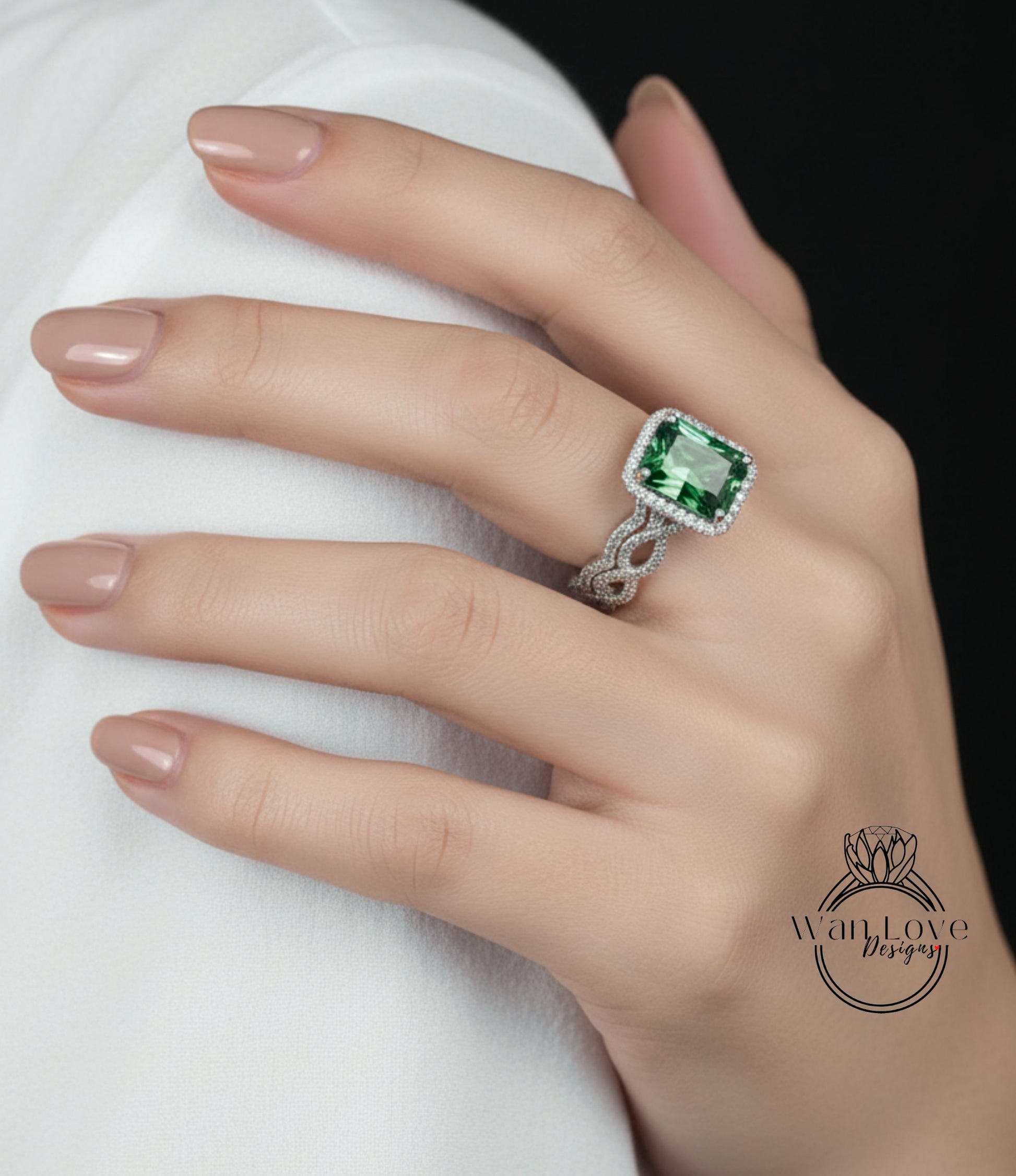 A close-up of a hand wearing a large, green gemstone ring with a diamond band.
