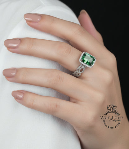 A close-up of a hand wearing a large, green gemstone ring with a diamond band.