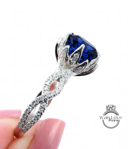 A close-up of a diamond engagement ring with a large blue gemstone set in a silver band.
