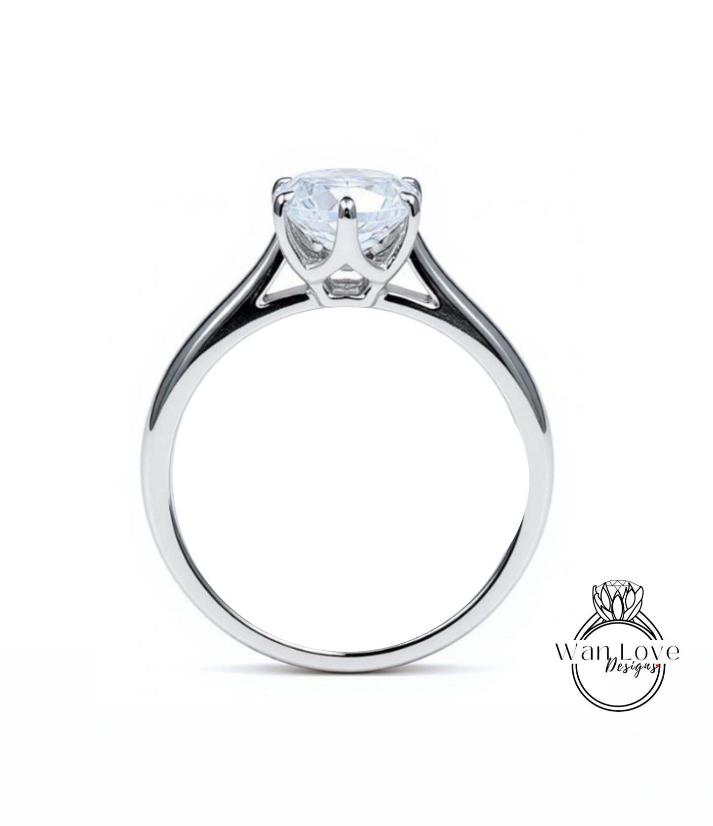 A silver engagement ring with a large, clear gemstone set in the center of the band.