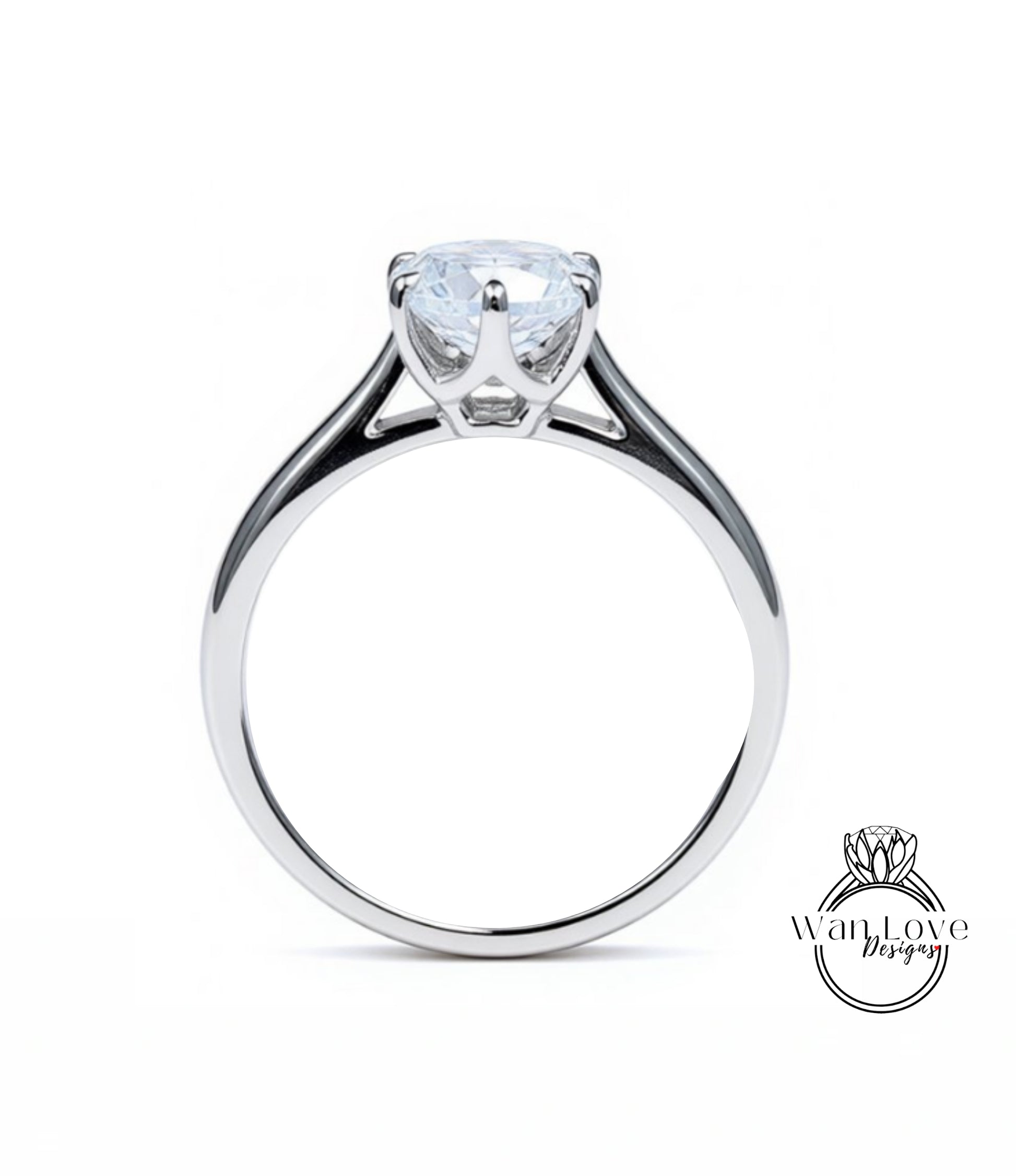 A silver engagement ring with a large, clear gemstone set in the center of the band.