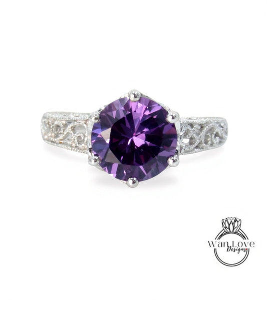 a beautiful purple gemstone ring with a silver band and intricate detailing.