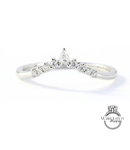 A silver ring with a large diamond in the center, surrounded by smaller diamonds, and a small diamond at the top.