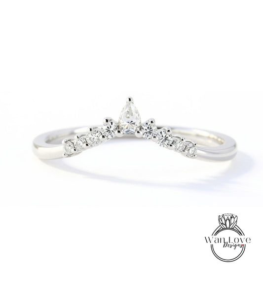 A silver ring with a large diamond in the center, surrounded by smaller diamonds, and a small diamond at the top.