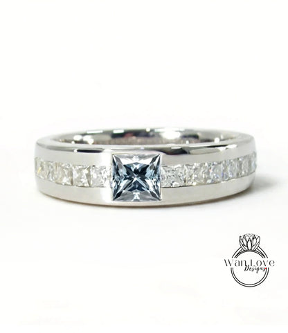 A silver ring with a large diamond in the center, surrounded by smaller diamonds along the band.
