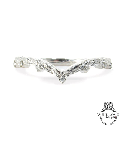 A silver ring with a leaf-like design on the band.