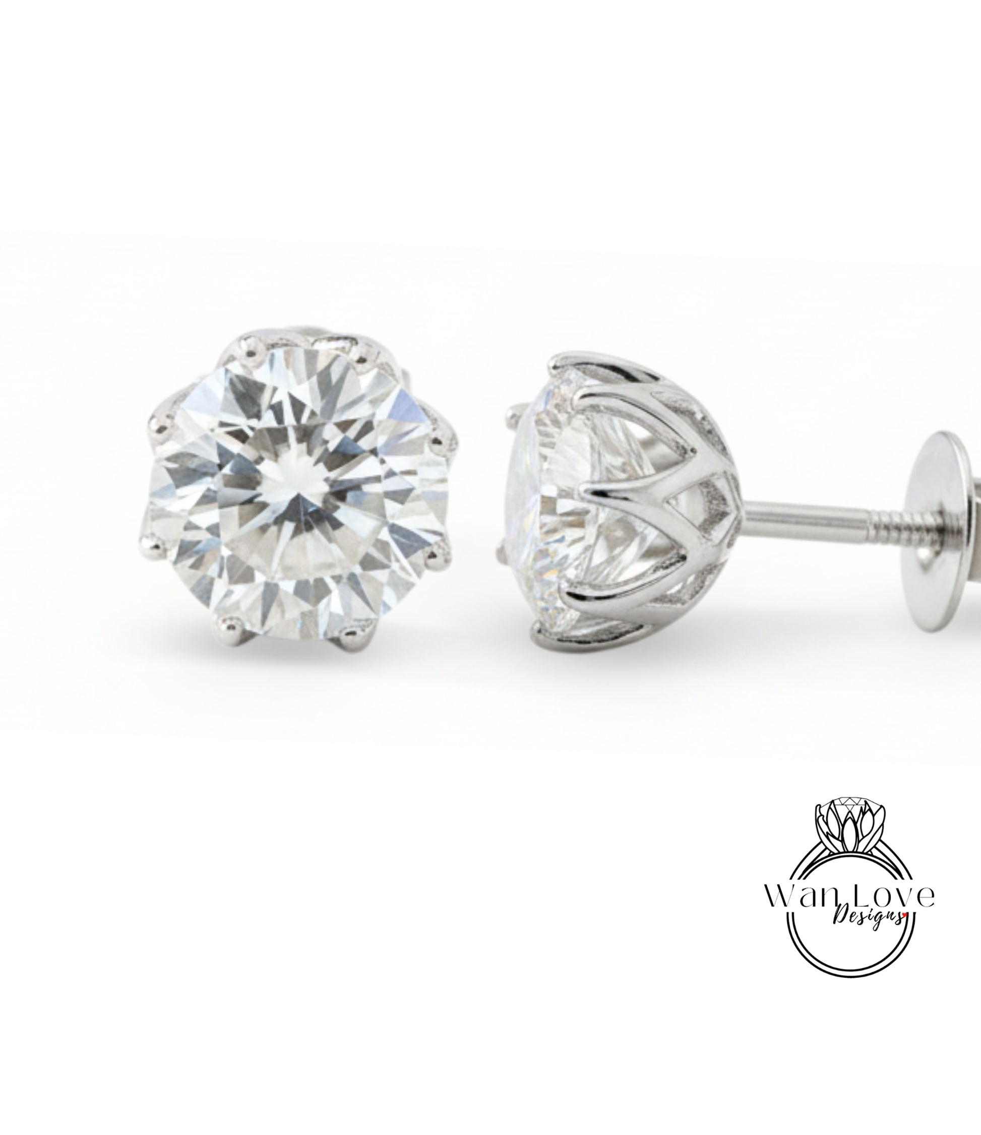 A pair of elegant diamond earrings with a large, brilliant-cut diamond set in a silver metal frame.