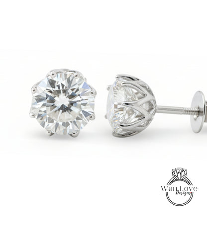 A pair of elegant diamond earrings with a large, brilliant-cut diamond set in a silver metal frame.
